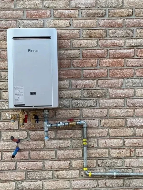 Tankless water heater installed on brick wall in a Pensacola home